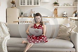 Pretty young girl enjoying leisure using laptop