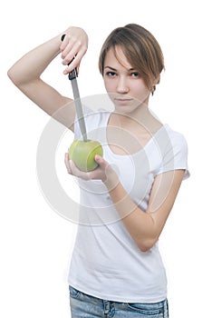 Pretty young girl with green apple and knife