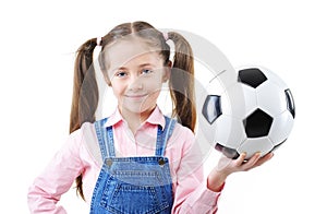 Pretty young girl holding a soccer ball