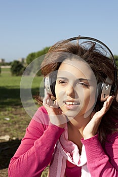 Pretty young girl listening music