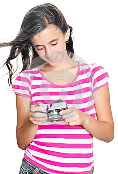 Pretty young girl looking at images on a compact camera