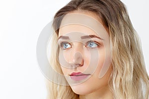 Pretty young girl with make-up poses in studio, close up