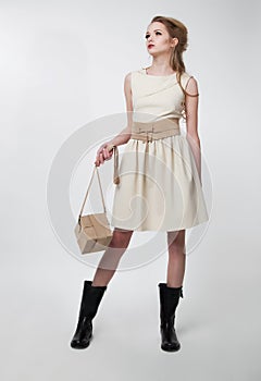 Pretty young girl in modern dress with purse