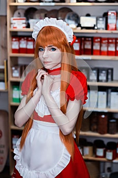 Pretty young girl servant costume portrait dressed in red in the shop