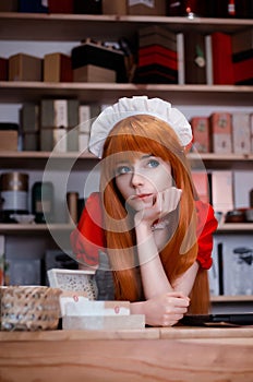 Pretty young girl servant costume portrait dressed in red in the shop