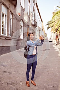 Pretty young girl taking a picture with cell phone