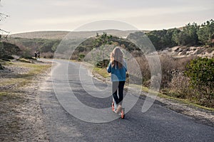 pretty young girl on vacation riding her scooter around a lake in south west France photo