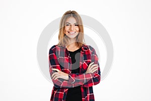 Pretty young happy woman standing with arms crossed