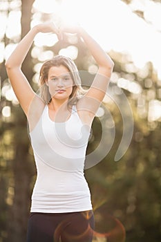 Pretty young jogger shaping heart with arms