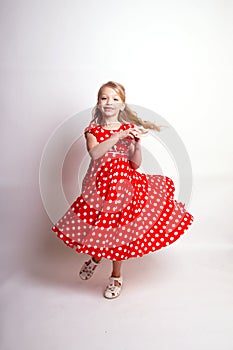 Pretty young kid girl  in red dress with gift box