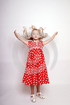 Pretty young kid girl  in red dress with gift box