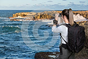 Pretty Young Lady with Binoculars at the Coast