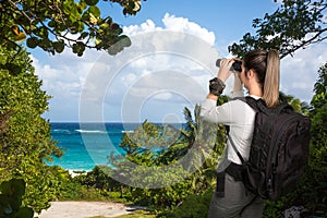 Pretty Young Lady with Binoculars at the Coast