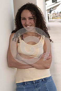 Pretty Young Latina with Curly Hair in Yellow Tank