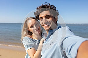 pretty young loving couple taking selfie together on smartphone