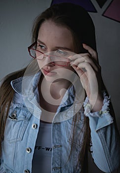 Pretty and young model with blue eyes using glasses photo