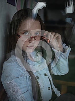 Pretty and young model with blue eyes using glasses photo