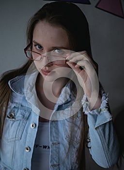 Pretty and young model with blue eyes using glasses photo