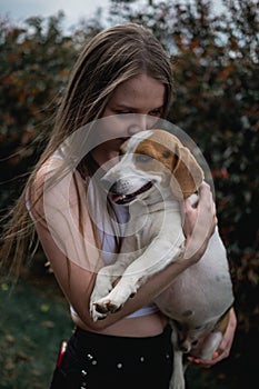 Pretty and young model with her dog photo