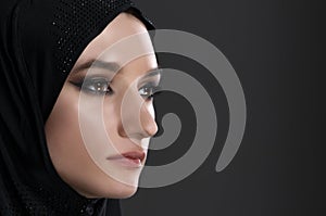 Pretty young muslim woman head shot over gray background