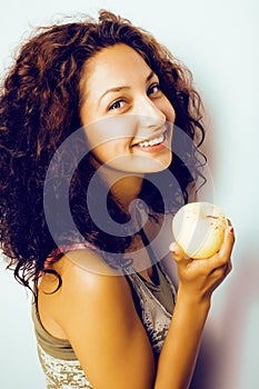 Pretty young real tenage girl eating apple close up smiling