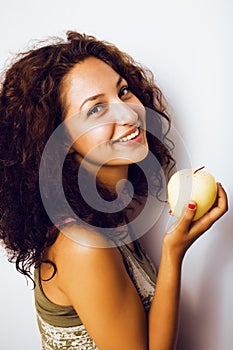 Pretty young real tenage girl eating apple close up smiling
