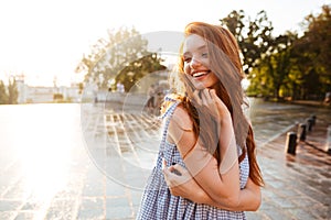 Pretty young redhead girl with long hair laughing