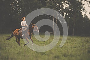 Pretty, young, redhead woman with her lovely horse