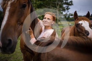 Pretty, young, redhead woman with her lovely horse