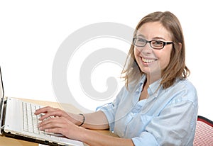 A pretty young secretary in his office smiling at the camera