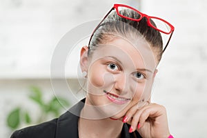 Pretty young secretary with red glasses