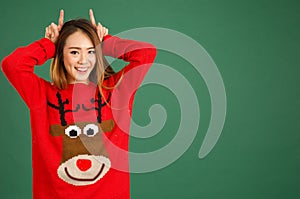 Pretty young singaporean girl wearing Christmas jumper and doing