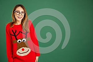 Pretty young singaporean girl wearing Christmas jumper and smiling