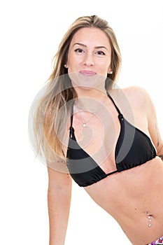 Pretty young slim blonde woman wearing stylish bikini sit on white background