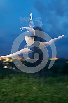 Pretty, young, smiling dancer performs splits in the air