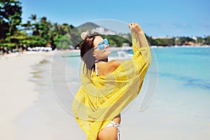 Pretty young tanned woman in bikini posing on the beach