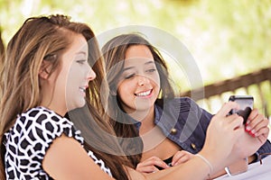 Pretty Young Teen Girlfriends Using Their Smart Phone