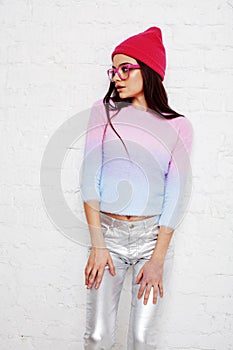 Pretty young teenage girl hipster in pink glasses and hat emotional posing happy smiling, lifestyle people concept