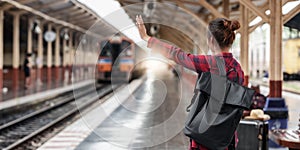 Pretty Young traveler woman planning trip at train station. Summer and travel lifestyle concept.