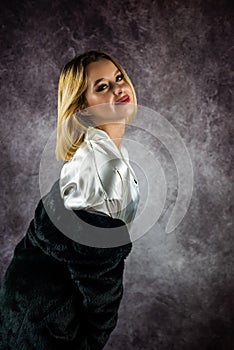 pretty young woman in a beautiful light silk robe with a warm fur coat on top.