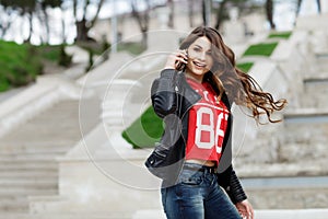 Pretty young woman with beautiful smile talking on mobile phone. Happy girl.