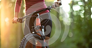 Pretty, young woman biking on a mountain bike