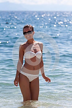 Pretty young woman in bikini in water