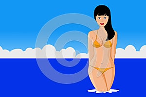 Pretty young woman in a bikini in the water on the beach