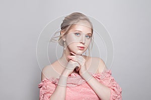 Pretty young woman with blonde hair on white background