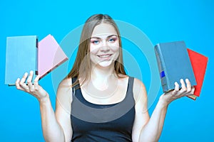 Pretty young woman with the books in the hands