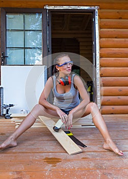 Pretty young woman builder having rest