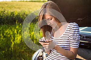 Pretty, young woman calling the roadside service