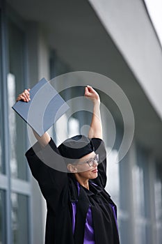 Pretty, young woman celebrating joyfully her graduation