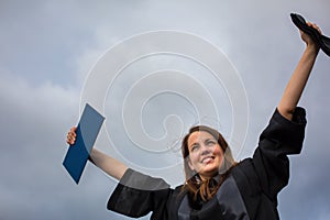 Pretty, young woman celebrating joyfully her graduation